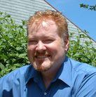 A man with red hair and a blue shirt.