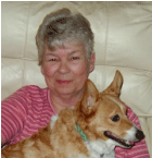 A woman sitting on the couch with her dog.